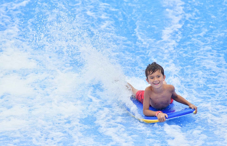 little boy on FlowRider
