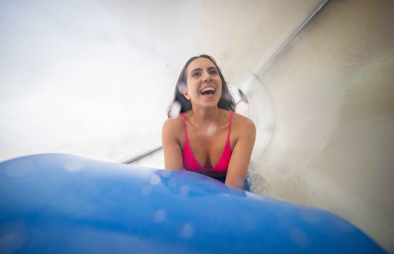 Woman sliding down water slide