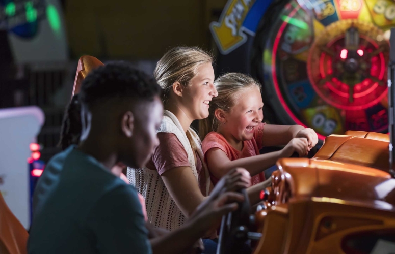 Two sisters playing an arcade game