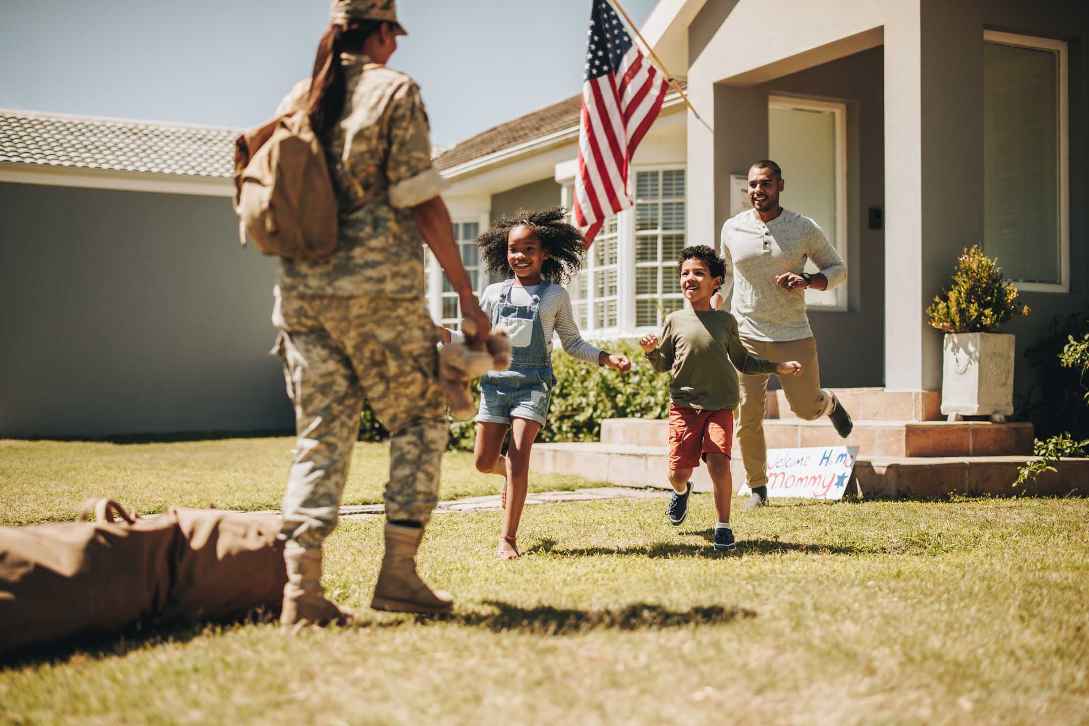 Military woman being welcomed home by her her family