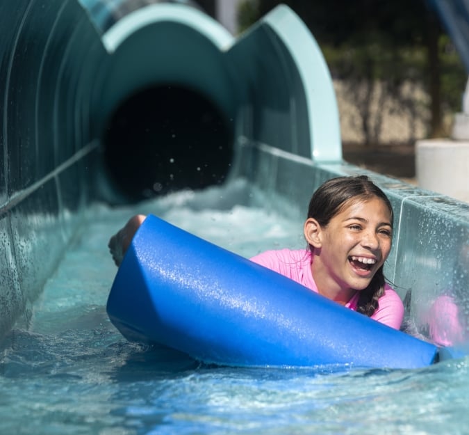 A girl rides down a water slide at Surf and Splash Orlando