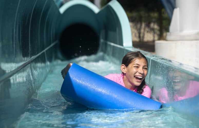 A girl rides down a water slide at Surf and Splash Orlando