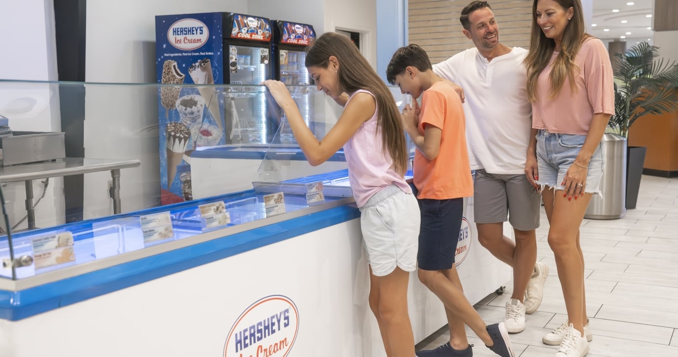 A family of four grabbing ice cream at Hershey's Ice Cream