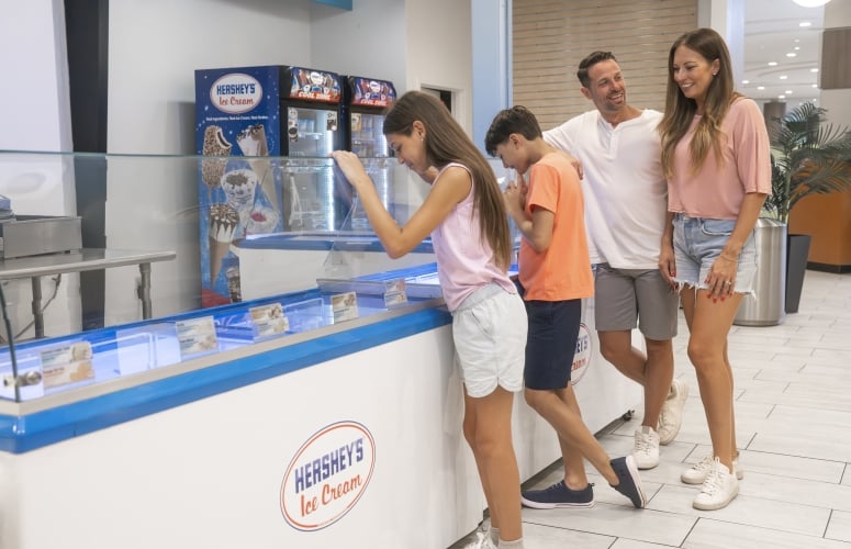 A family of four grabbing ice cream at Hershey's Ice Cream
