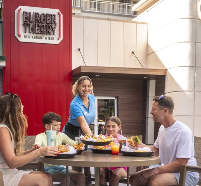 A Family of four dines outside at Burger Theory Restaurant and Bar